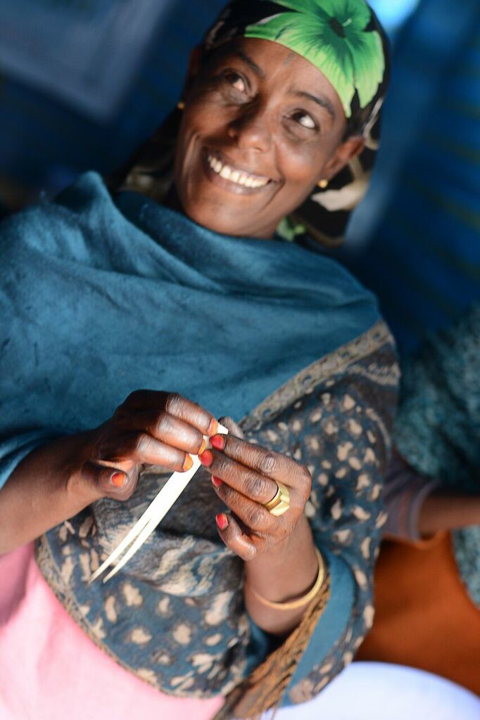 Ethiopian woman making beads