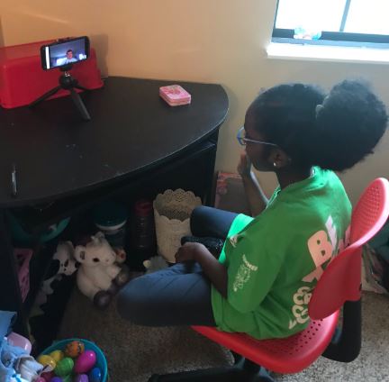 Mihret talking with her classmates for a virtual class meeting during quarantine