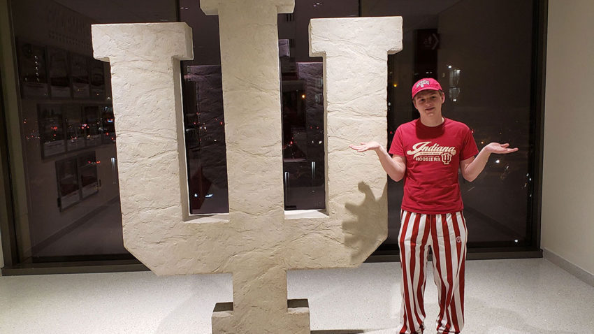 Aiden shrugging shoulders in front of the IU symbol at Assembly Hall where the Hoosiers play basketball