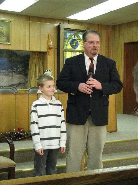 Me introducing Aiden to the church as a baptism candidate.