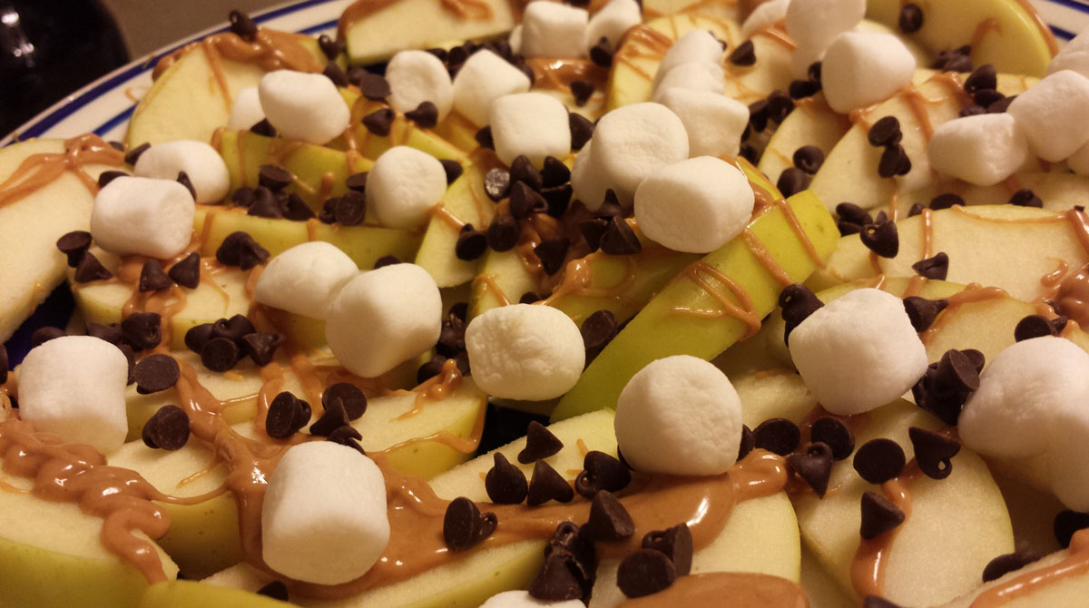 Apple nachos - sliced apples, melted peanut butter, chocolate chips, and marshmallows